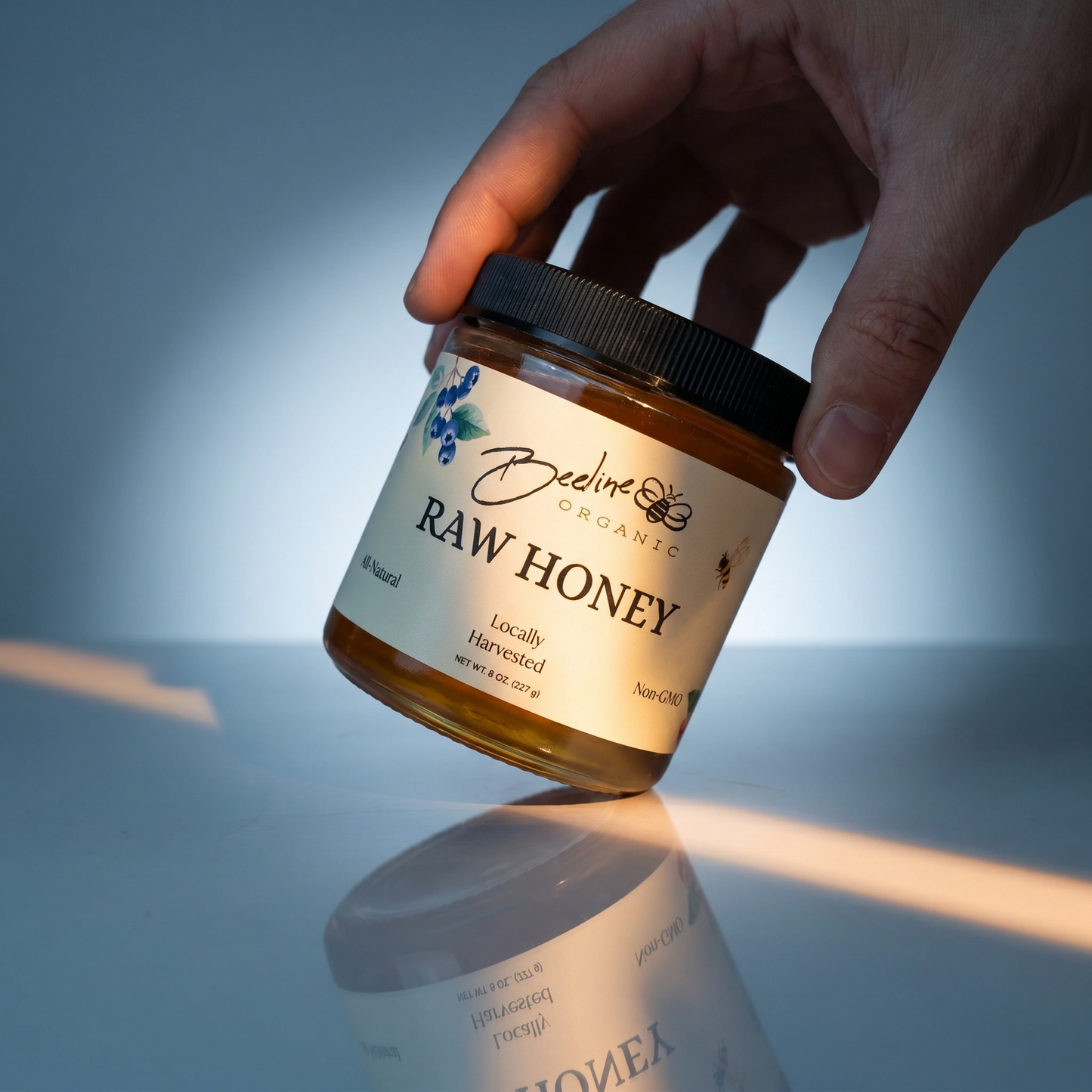 An 8oz glass jar of raw, unfiltered Berry Blossom honey from Beeline Organic in Washington