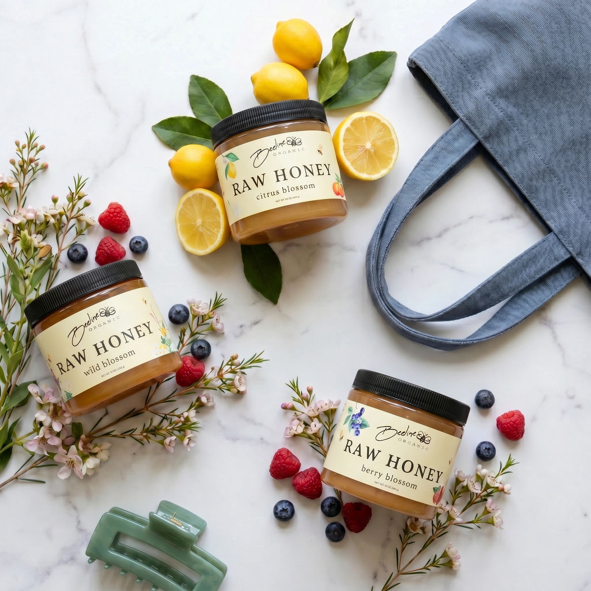 Three 16-ounce jars of Citrus Blossom, Berry Blossom, and Wild Blossom raw honey