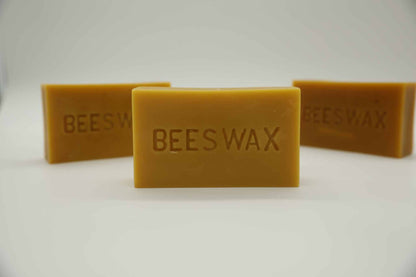 Natural beeswax brick close up — golden raw beeswax produced by Beeline Organic bees in Washington State